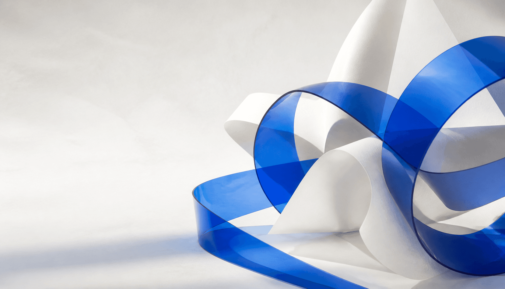 Abstract blue ribbons interlocking to represent collaboration
